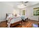 Bedroom with hardwood floors, ceiling fan, and bright natural light from large windows at 1691 Houghton N Ct, Atlanta, GA 30338