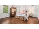 Bedroom featuring a four-poster bed, hardwood floors, and plenty of natural light at 1691 Houghton N Ct, Atlanta, GA 30338