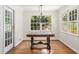 Bright dining room featuring hardwood floors, large windows, and stylish lighting fixture at 1691 Houghton N Ct, Atlanta, GA 30338