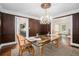 View of dining room with chandelier looking into the butler's pantry and living room at 1691 Houghton N Ct, Atlanta, GA 30338