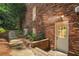 Exterior brick home with white trim, and door leading to the backyard at 1691 Houghton N Ct, Atlanta, GA 30338