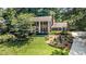 Charming two-story brick home with a manicured front lawn and mature trees at 1691 Houghton N Ct, Atlanta, GA 30338