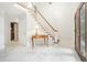 Bright foyer with marble floors, staircase and charming table at 1691 Houghton N Ct, Atlanta, GA 30338