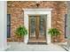 Elegant front door with intricate glass detailing, complemented by brick and white trim at 1691 Houghton N Ct, Atlanta, GA 30338