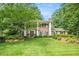 Charming two-story brick home with a lush green lawn and mature trees at 1691 Houghton N Ct, Atlanta, GA 30338