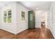 Hallway boasts hardwood floors, white trim, and a view of a bright room, seamlessly connecting the spaces at 1691 Houghton N Ct, Atlanta, GA 30338