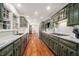 Spacious kitchen featuring custom green cabinetry, granite countertops, and stainless steel appliances at 1691 Houghton N Ct, Atlanta, GA 30338