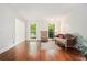 Sunlit living room with hardwood floors and elegant furnishings create a welcoming atmosphere at 1691 Houghton N Ct, Atlanta, GA 30338