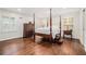 Spacious main bedroom features hardwood floors, a four-poster bed, and abundant natural light at 1691 Houghton N Ct, Atlanta, GA 30338