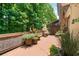 Secluded back deck, surrounded by lush trees, offering a peaceful outdoor retreat with potted plants at 3401 Village Green Dr, Roswell, GA 30075
