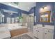 A spacious primary bathroom features a soaking tub, glass-enclosed shower, and double vanities at 3401 Village Green Dr, Roswell, GA 30075