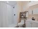 Well-lit bathroom with tiled shower, white vanity, and modern fixtures at 3401 Village Green Dr, Roswell, GA 30075