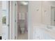 Bright bathroom featuring white vanity, tile flooring, a toilet, and a window at 3401 Village Green Dr, Roswell, GA 30075