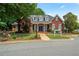 Elegant brick clubhouse with manicured landscaping, offering a welcoming community space at 3401 Village Green Dr, Roswell, GA 30075