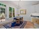 Bright dining room with hardwood floors, modern chandelier, and access to the outdoor patio at 3401 Village Green Dr, Roswell, GA 30075