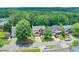 Aerial view of a red brick home and driveway surrounded by lush trees and landscaping at 508 Keeneland Ave, Woodstock, GA 30189