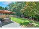 A backyard with a large, covered seating area, playset and grassy space at 508 Keeneland Ave, Woodstock, GA 30189