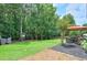 Spacious backyard with patio seating, playset, gazebo, and professionally landscaped grounds at 508 Keeneland Ave, Woodstock, GA 30189