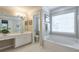 Well-lit bathroom featuring a soaking tub, and a separate vanity area at 508 Keeneland Ave, Woodstock, GA 30189