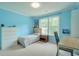 Bedroom with hardwood floors, light blue paint, and a picture window at 508 Keeneland Ave, Woodstock, GA 30189