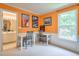 Bright bedroom with orange walls, built-in desks, and a view to the ensuite bathroom at 508 Keeneland Ave, Woodstock, GA 30189