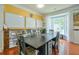 Dining room with yellow walls, a large bay window, and built-in bookshelves at 508 Keeneland Ave, Woodstock, GA 30189