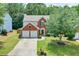 Two-story brick home with a landscaped front yard, driveway and a two-car garage at 508 Keeneland Ave, Woodstock, GA 30189