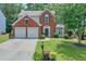 Charming two-story brick home featuring a manicured lawn and a two-car garage at 508 Keeneland Ave, Woodstock, GA 30189