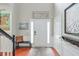 Welcoming foyer with hardwood floors, a bench, and decorative art at 508 Keeneland Ave, Woodstock, GA 30189