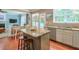 Kitchen with island, counter seating, and view to dining area at 508 Keeneland Ave, Woodstock, GA 30189