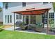 Inviting patio area with comfortable seating under an orange gazebo, ideal for relaxing and entertaining outdoors at 508 Keeneland Ave, Woodstock, GA 30189