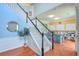 Bright foyer features a staircase with white railings and hardwood floors at 508 Keeneland Ave, Woodstock, GA 30189