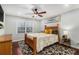 Bright bedroom featuring a wooden bed frame, ceiling fan, and stylish decor, creating a cozy and inviting atmosphere at 64 Montre Nw Sq, Atlanta, GA 30327