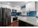 Modern kitchen features stainless steel appliances, ample counter space, and stylish backsplash at 64 Montre Nw Sq, Atlanta, GA 30327