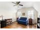 Bedroom is lit by a ceiling fan and two windows and contains a blue loveseat and other furniture at 348 7Th Ne St, Atlanta, GA 30308