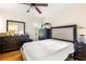 Bright bedroom with a ceiling fan, dresser and a dark, upholstered bed frame on hardwood floors at 348 7Th Ne St, Atlanta, GA 30308