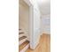 Hallway with open door, light colored walls, and hardwood floors plus open stairway at 348 7Th Ne St, Atlanta, GA 30308