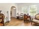 Inviting living space with hardwood floors, arched doorway, large windows, and vintage decor at 348 7Th Ne St, Atlanta, GA 30308