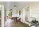 Screened porch with a ceiling fan, a table, and comfortable seating to sit and relax in at 348 7Th Ne St, Atlanta, GA 30308