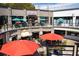 Multi-level shopping center with outdoor seating and colorful umbrellas at 348 7Th Ne St, Atlanta, GA 30308