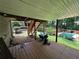 Backyard with wooden deck overlooking manicured landscaping and pool, creating a serene outdoor oasis at 4819 Coppedge Trl, Peachtree Corners, GA 30096