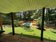 Backyard with wood deck overlooking a private swimming pool and landscaping at 4819 Coppedge Trl, Peachtree Corners, GA 30096