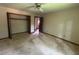 A bright bedroom features a ceiling fan and closet space for comfortable living and storage at 4819 Coppedge Trl, Peachtree Corners, GA 30096