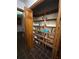 Walk-in closet with ample shelving for storage and organization, accessed by a wooden door at 4819 Coppedge Trl, Peachtree Corners, GA 30096
