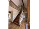 The foyer features hardwood floors, a wooden staircase, and modern chandelier at 4819 Coppedge Trl, Peachtree Corners, GA 30096