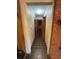 Hallway featuring tile flooring, neutral walls, and wood trim leading to other rooms in the home at 4819 Coppedge Trl, Peachtree Corners, GA 30096