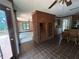 Open kitchen featuring tile flooring, a brick half-wall, oak cabinets, and access to an outdoor deck at 4819 Coppedge Trl, Peachtree Corners, GA 30096