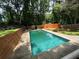 Backyard swimming pool surrounded by a wooden fence and tall trees provides a private outdoor retreat at 4819 Coppedge Trl, Peachtree Corners, GA 30096