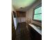 Small room featuring tile floors, built-in cabinets, desk, and a window providing natural light at 4819 Coppedge Trl, Peachtree Corners, GA 30096