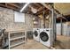 Basement laundry area featuring a washer, dryer, and shelving along the walls at 733 Greenview Ne Ave, Atlanta, GA 30305